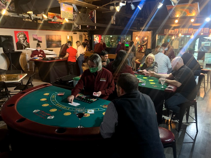 Group of people in a casino venue playing poker games