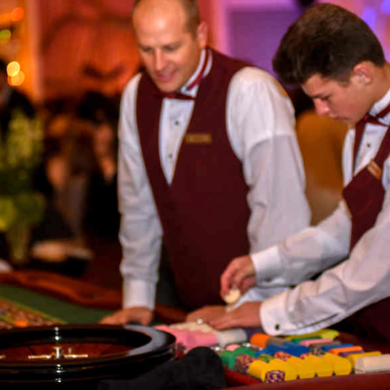 People playing Craps at a Common Cents Casino Party.