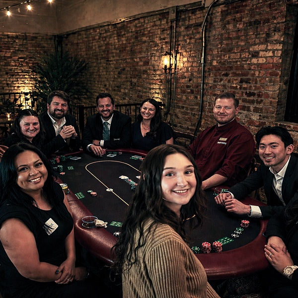 Happy people playing Texas Hold'em casino style card game.
